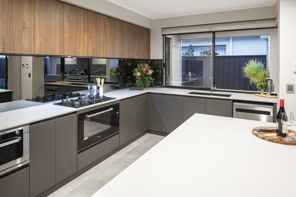 Stylish modern kitchen with mirrored splashback