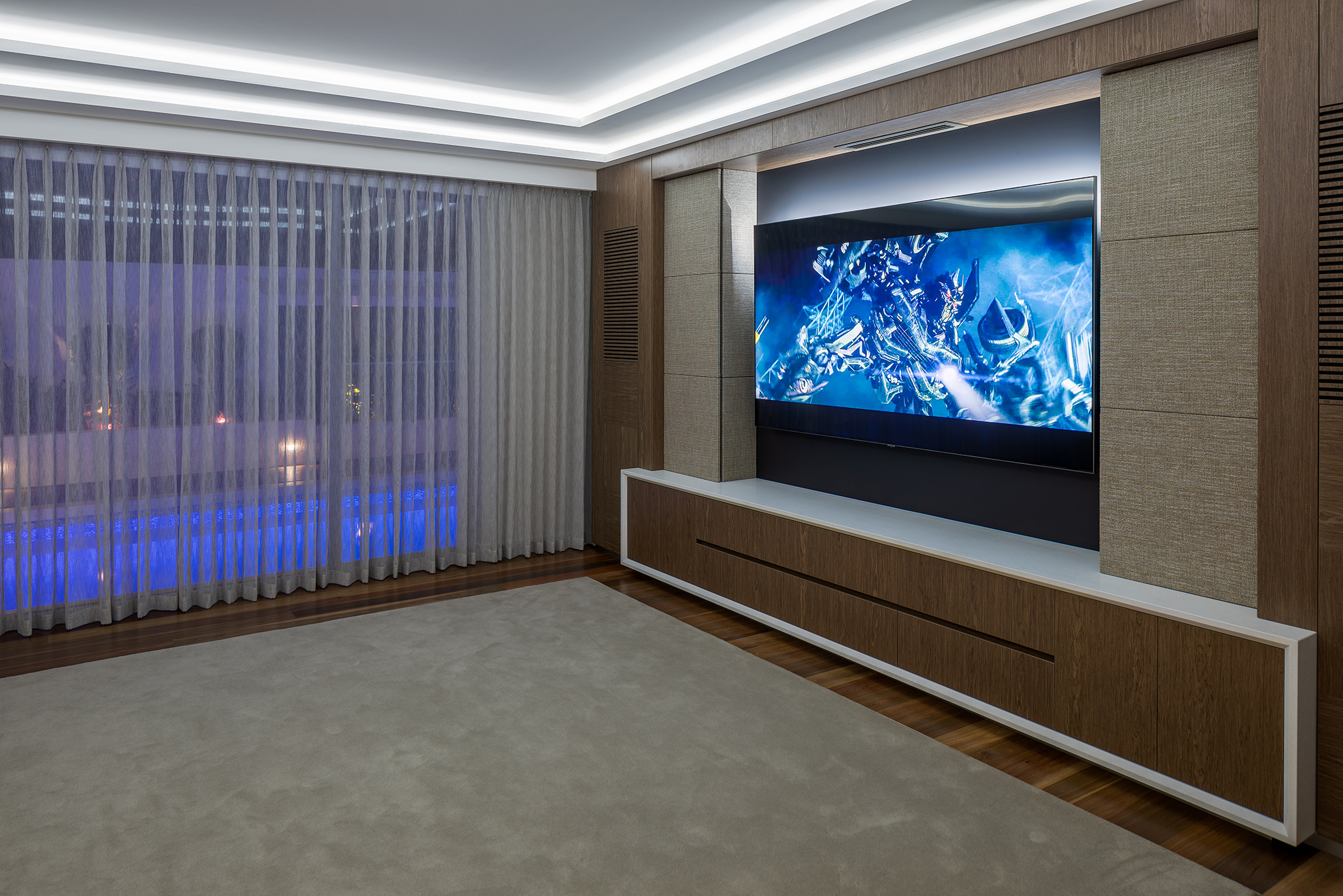 Home theatre system with wooden panels and large screen tv