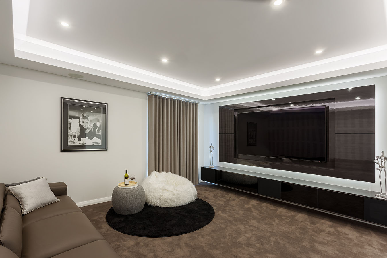 White and brown home theatre with large screen tv